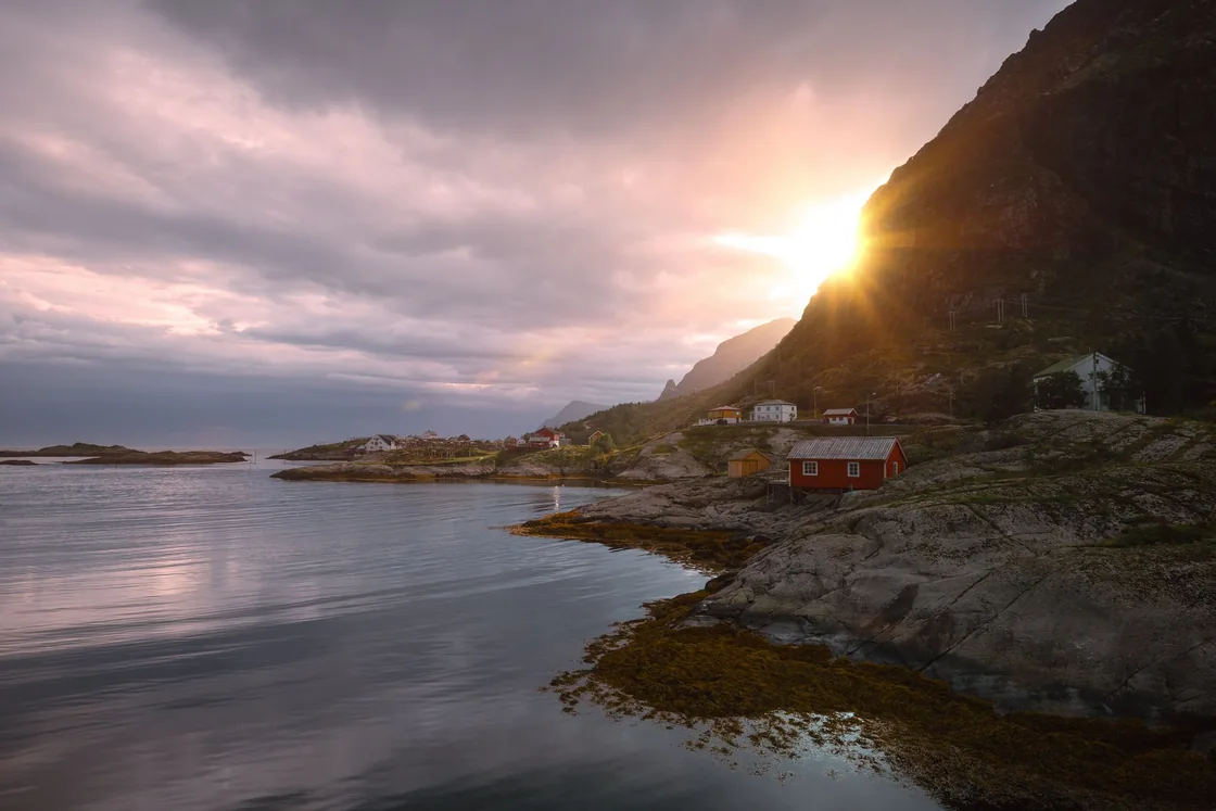 Warm evening sunlight over a quiet fjord in the Lofoten Islands